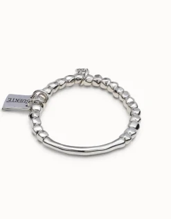 Beaded stretch bracelet with tubular piece and a charm