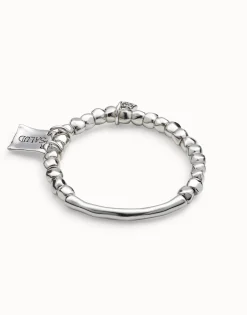 Beaded stretch bracelet with tubular piece and charms