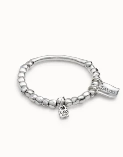 Beaded stretch bracelet with tubular piece and charms