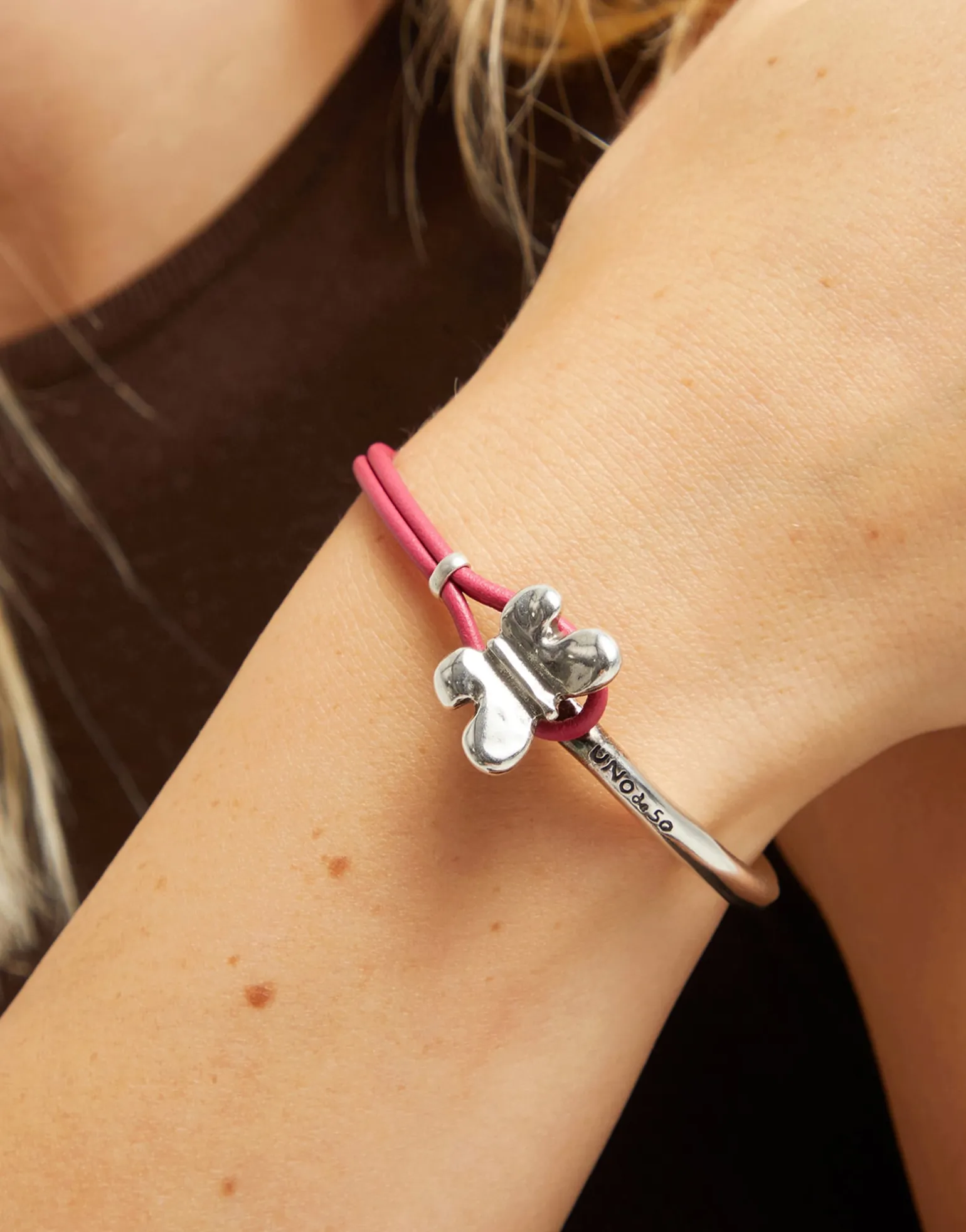 Pink leather bracelet with butterfly ornament